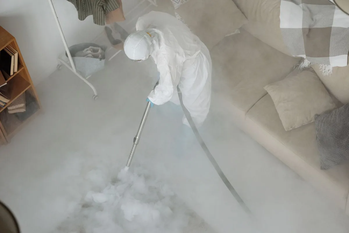 Biohazard cleanup technician in protective equipment, New London, MN